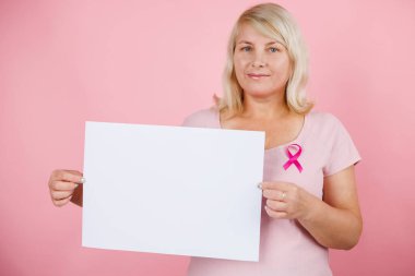 Woman doctor take bliiboard and show something with breast cancer prevent concept. High quality photo