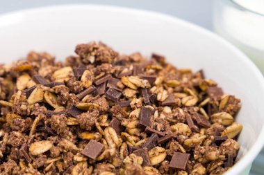 Chocolate granola, crispy muesli in a bowl. Selective focus.