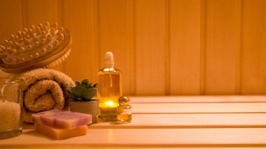 spa concept-aromatherapy with massage accessories, bottle, towels, and oil, on wooden surface