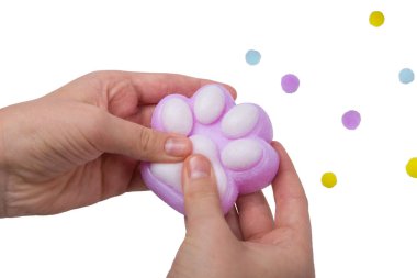 Pink toy cat paw in the hand isolated on a white background. Decompression squeeze toy. clipart