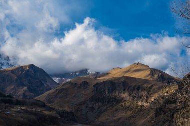 Kazbegi, Georgia : 10-11-2022 : Panoramic landscape of beautiful natural mountains, view of amazing Caucasus mountain peaks and meadows in Kazbegi national park,  Country of Georgia.