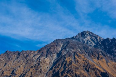 Georgia : 10-11-2022 : Country of Georgia, Kazbegi, Panoramic landscape of beautiful natural mountains, view of amazing Caucasus mountain peaks and meadows in Kazbegi national park.
