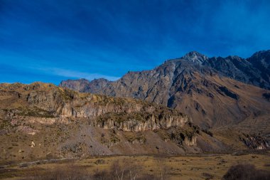 Georgia : 10-11-2022 : Country of Georgia, Kazbegi, Panoramic landscape of beautiful natural mountains, view of amazing Caucasus mountain peaks and meadows in Kazbegi national park.