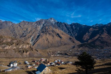 Kazbegi, Georgia : 10-11-2022 : Aerial view of Stepantsminda Kazbegi, Georgia, Panoramic landscape of beautiful natural mountains view of beautiful Caucasus mountain peaks and meadow
