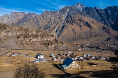 Kazbegi, Georgia : 10-11-2022 : Aerial view of Stepantsminda Kazbegi, Georgia, Panoramic landscape of beautiful natural mountains view of beautiful Caucasus mountain peaks and meadow
