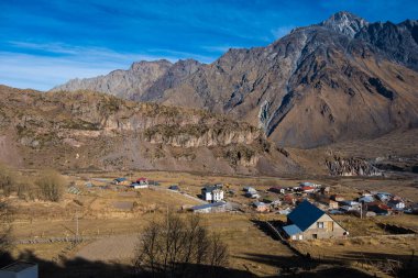 Kazbegi, Georgia : 10-11-2022 : Aerial view of Stepantsminda Kazbegi, Georgia, Panoramic landscape of beautiful natural mountains view of beautiful Caucasus mountain peaks and meadow
