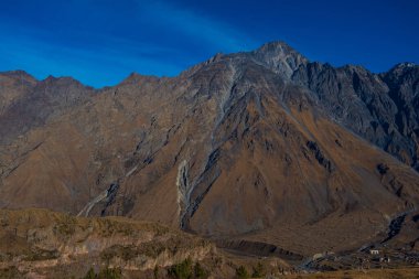 Georgia : 10-11-2022 : Country of Georgia, Kazbegi, Panoramic landscape of beautiful natural mountains, view of amazing Caucasus mountain peaks and meadows in Kazbegi national park.