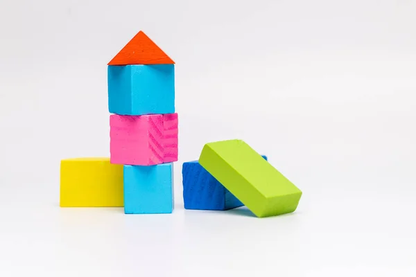 house toy blocks isolated white background, little wooden home, A partially constructed home, built from colorful wood blocks building isolated on white background. Colourful shapes with blocks