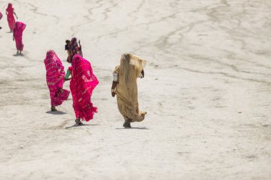 Hingol Pakistan March 2022, Women Hindu yatris pilgrims visit mud volcanoes which are situated in Sapat village and perform there certain pujas and rituals as part of the Hinglaj Pilgrimage, Hindu women wearing colorfull traditional dresses. clipart