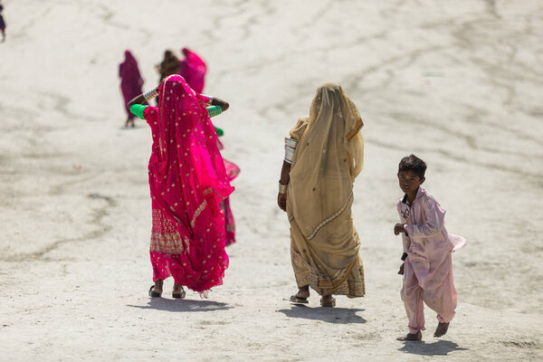 Hingol Pakistan March 2022, Women Hindu yatris pilgrims visit mud volcanoes which are situated in Sapat village and perform there certain pujas and rituals as part of the Hinglaj Pilgrimage, Hindu women wearing colorfull traditional dresses.
