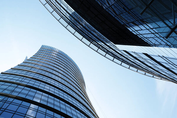 Modern architecture in the financial area, reflections and blue sky in Warsaw, Poland