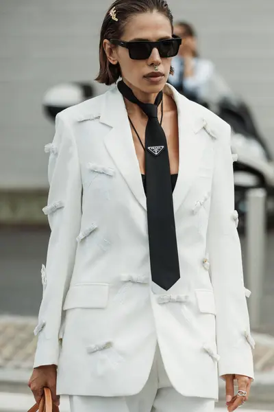 stock image A guest wears  white pant suit,  black Prada tie, black platform sandals, and  bag seen outside PRADA show during Milan Fashion Week Womenswear Spring/Summer 2024.