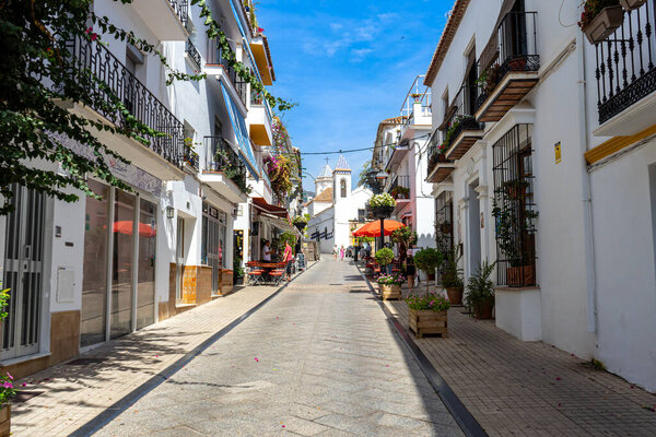 MARBELLA, SPAIN - SEPTEMBER 11, 2022: Walking on the white streets in Marbella, Spain on September 11, 2022
