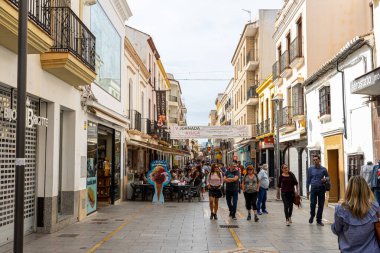 RONDA, SPAIN - OCTOBER 23, 2022: Walking on white cozy streets in Ronda, Spain on October 23, 2022