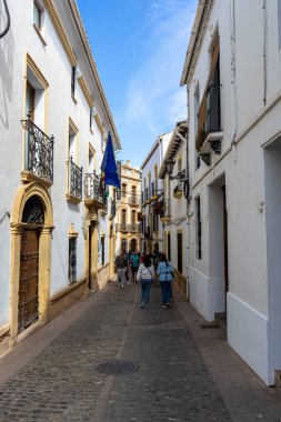 RONDA, SPAIN - OCTOBER 23, 2022: Walking on white cozy streets in Ronda, Spain on October 23, 2022