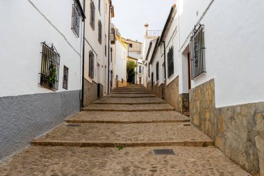 RONDA, SPAIN - OCTOBER 23, 2022: Walking on white cozy streets in Ronda, Spain on October 23, 2022