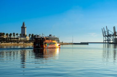 MALAGA, SPAIN - JANUARY 14, 2023: Catamaran cruise on sunset in port in Malaga, Spain on January 14, 2023