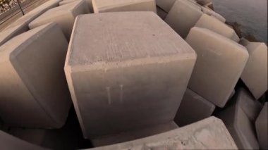 MALAGA, SPAIN - JANUARY 14, 2023: Walking on stones of the breakwater in Malaga, Spain on January 14, 2023