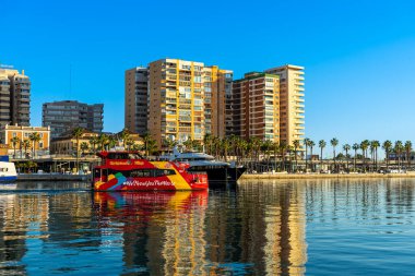 MALAGA, SPAIN - JANUARY 14, 2023: Catamaran cruise on sunset in port in Malaga, Spain on January 14, 2023