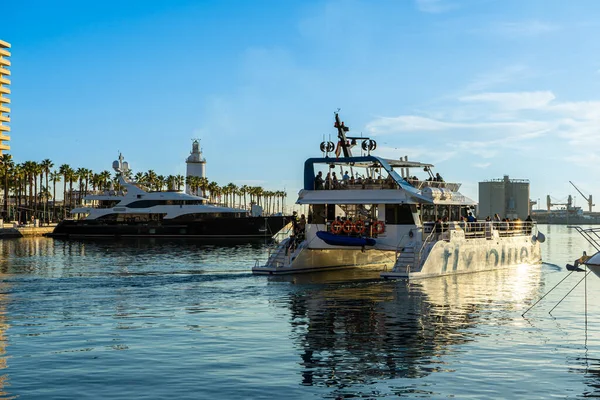 MALAGA, SPAIN - JANUARY 14, 2023: Catamaran cruise on sunset in port in Malaga, Spain on January 14, 2023