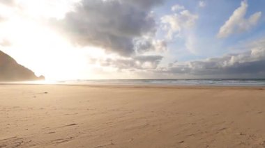 Kayalık uçurum kıyıları ve dalgaların üzerine çöktüğü cennet manzarası. Sörfçü Praia do Castelejo 'daki kayalar Sagres yakınlarında. Portekiz 'in güneyindeki Algarve bölgesinin Batı Atlantik kıyıları.