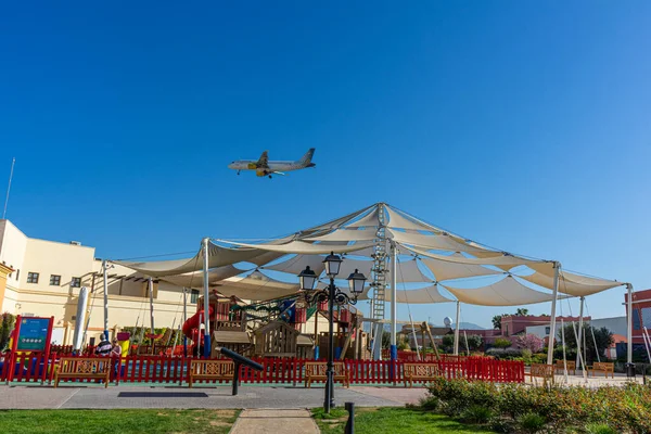 Stock image MALAGA, SPAIN - MARCH 10, 2023: Aircraft landing over Plaza Mayor in Malaga, Spain on March 10, 2023