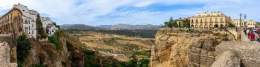 RONDA, SPAIN - OCTOBER 23, 2022: Panoramic view of canyon of Ronda near new Bridge in Ronda, Spain on October 23, 2022