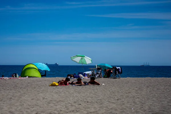 stock image TORREMOLINOS, SPAIN - APRIL 23, 2023: Beach umbrellas on the Beach in Torremolinos, Spain on April 23, 2023