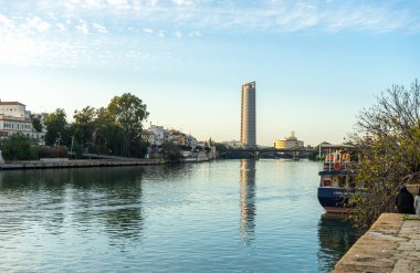 SEVILLA, İspanya - 1 Ocak 2023: Guadalquivir nehri Sevilla, İspanya 'da gün batımında 1 Ocak 2023