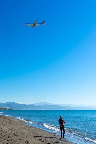 Stock image MALAGA, SPAIN - MARCH 25, 2023: Airplane landing at sunrise over Mediterranean Sea, Costa del Sol in Malaga, Spain on March 25, 2023