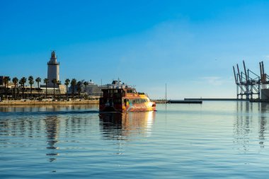 MALAGA, SPAIN - JANUARY 14, 2023: Catamaran cruise on sunset in port in Malaga, Spain on January 14, 2023