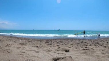 TORREMOLINOS, İspanya - 28 Mayıs 2023: Torremolinos, İspanya sahilindeki sörfçüler 28 Mayıs 2023