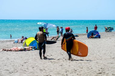 TORREMOLINOS, İspanya - 28 Mayıs 2023: Torremolinos, İspanya sahilindeki sörfçüler 28 Mayıs 2023
