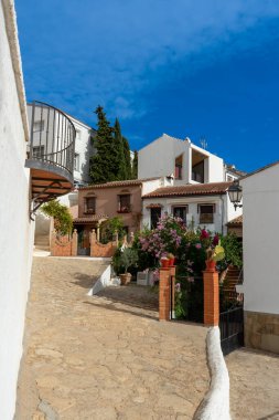 RONDA, SPAIN - OCTOBER 23, 2022: Walking on white cozy streets in Ronda, Spain on October 23, 2022