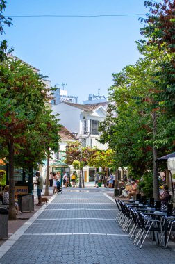 ESTEPONA, İspanya - 29 Temmuz 2023 'te İspanya' nın Estepona kentinde güneşli bir yaz gününde şehir merkezinde yürüyüş