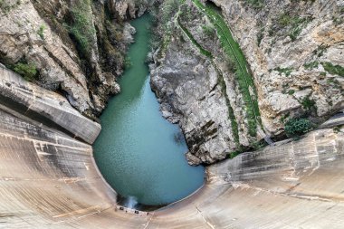 Reservoir dam at Quentar on cloudy weather, Granada province, Andalusia, Spain clipart
