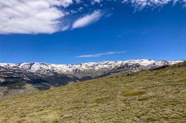 Panoramic view on snowy mountains on hiking trail to Mulhacen peak in the spring, Sierra Nevada range, Andalusia, Spain clipart