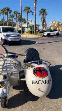 TORREMOLINOS, İspanya - 18 Haziran 2024: 18 Haziran 2024 'te İspanya' nın Torremolinos kentindeki deniz gezinti alanında park etmiş motosiklet üzerindeki Bacardi tabelası