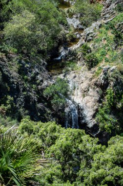 Hiking trail to waterfalls over river Caballos, Sierra de la Nieves National Park in Tolox, Malaga, Spain clipart