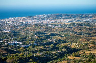 MIJAS, SPAIN - 7 Temmuz 2024: Kosta del Sol 'a tepeden bakan, İspanya' nın Endülüs kentindeki Mijas, Endülüs kentindeki beyaz yıkanmış binalar köyü ile tanınan büyüleyici beyaz İspanyol köyü