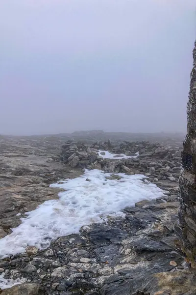 stock image Snowy wind and fog on Maroma peak in thunderstorm day, Sierra Tejeda, Spain 