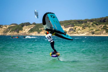 TARIFA, SPAIN - MAY 25, 2024: Enjoying kitesurfing on Valdevaqueros beach, Gibraltar Strait in Tarifa, Spain on May 25, 2024 clipart