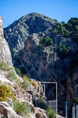 Hiking trail to Colgante bridge (Puente Colgante El Saltillo) over Almanchares river, Sierra Tejeda, Andalusia, Spain clipart