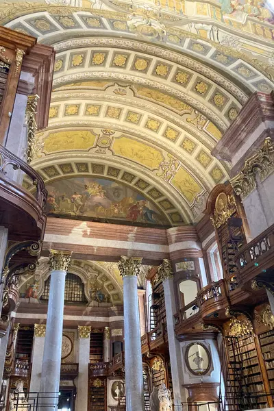 stock image VIENNA, AUSTRIA - JULY 18, 2024:  Baroque State Hall with ceiling frescoes housing National Library including papyrus in Vienna, Austria on July 18, 2024