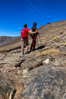 SIERRA NEVADA, SPAIN - OCTOBER 5, 2024: Hiking trail to Mulhacen peak in the spring in Sierra Nevada National Park, Spain on OCTOBER 5, 2024 clipart