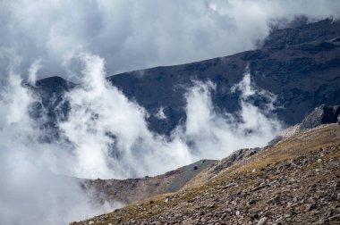 Cloudy over mountains on hiking trail to Mulhacen peak, Sierra Nevada National park, Andalusia, Spain clipart