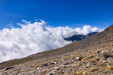 Cloudy over mountains on hiking trail to Mulhacen peak, Sierra Nevada National park, Andalusia, Spain clipart