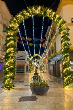 BENALMADENA, SPAIN - DECEMBER 14, 2024: Benalmadena sparkles with festive Christmas lights and decorations, creating a magical holiday atmosphere clipart