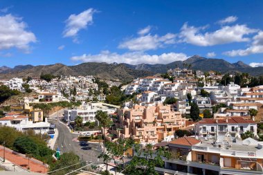 NERJA, İspanya - 22 Mart 2025: Işıldayan deniz ve büyüleyici şehrin muhteşem manzaraları, 22 Mart 2025 tarihinde İspanya 'nın Nerja kentinde nefes kesen kıyı manzaraları ve pitoresk bir atmosfer sunuyor.