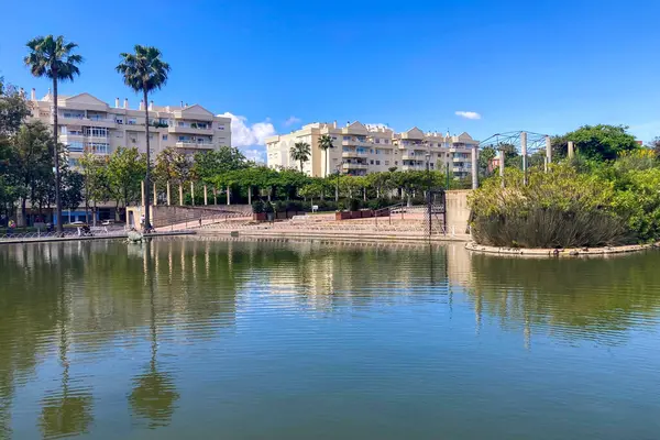 MALAGA, İspanya - 3 Mayıs 2025: Malaga, İspanya 'daki Batı Park' ta yemyeşil ve huzurlu yollarla çevrili sakin bir sabah yürüyüşünün tadını çıkarmak.